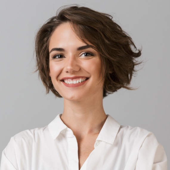 Patient holding up a dental shade guide guide to her teeth